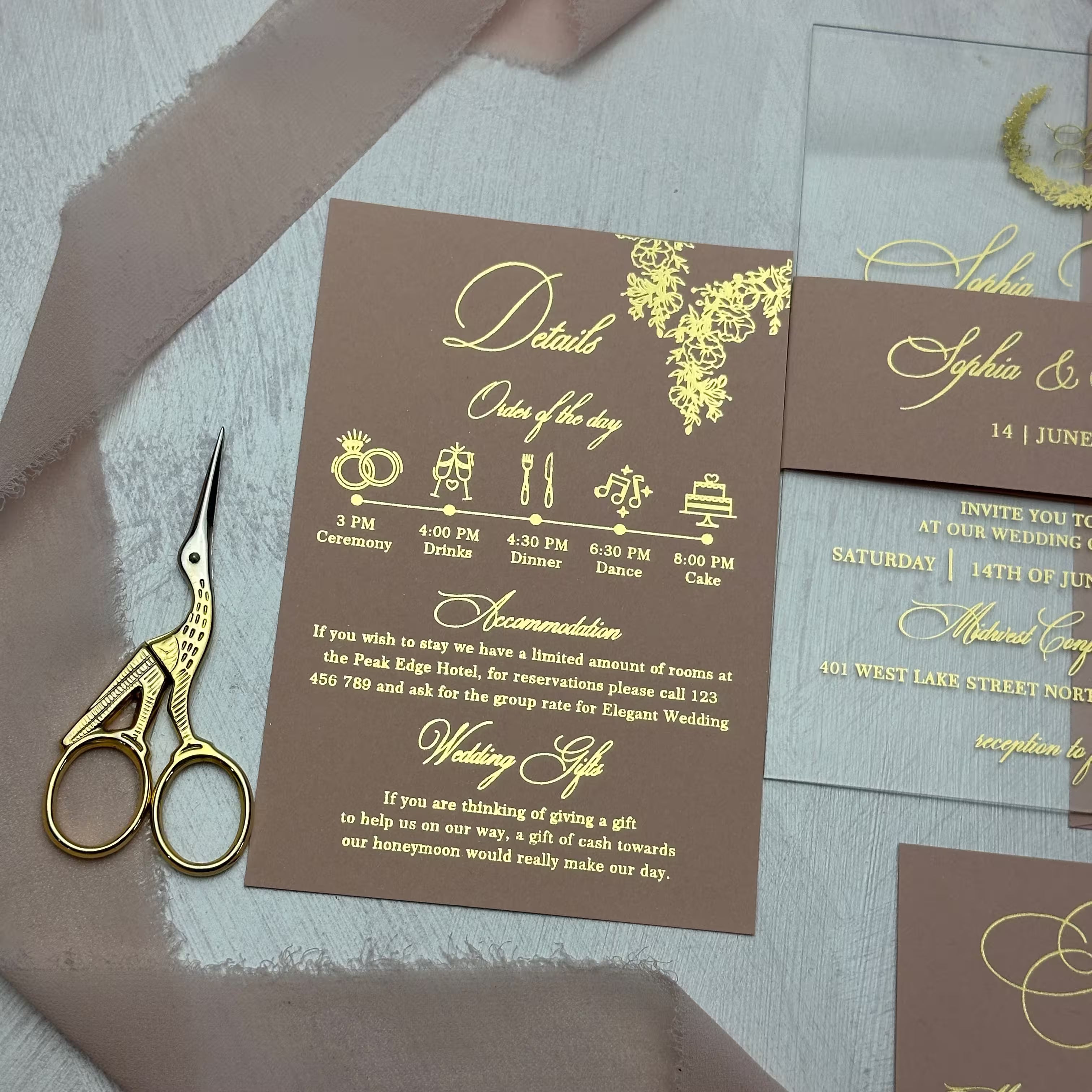 Wedding details card in gold foil with the order of the day timeline, accommodation and gift notes beneath a foil floral corner