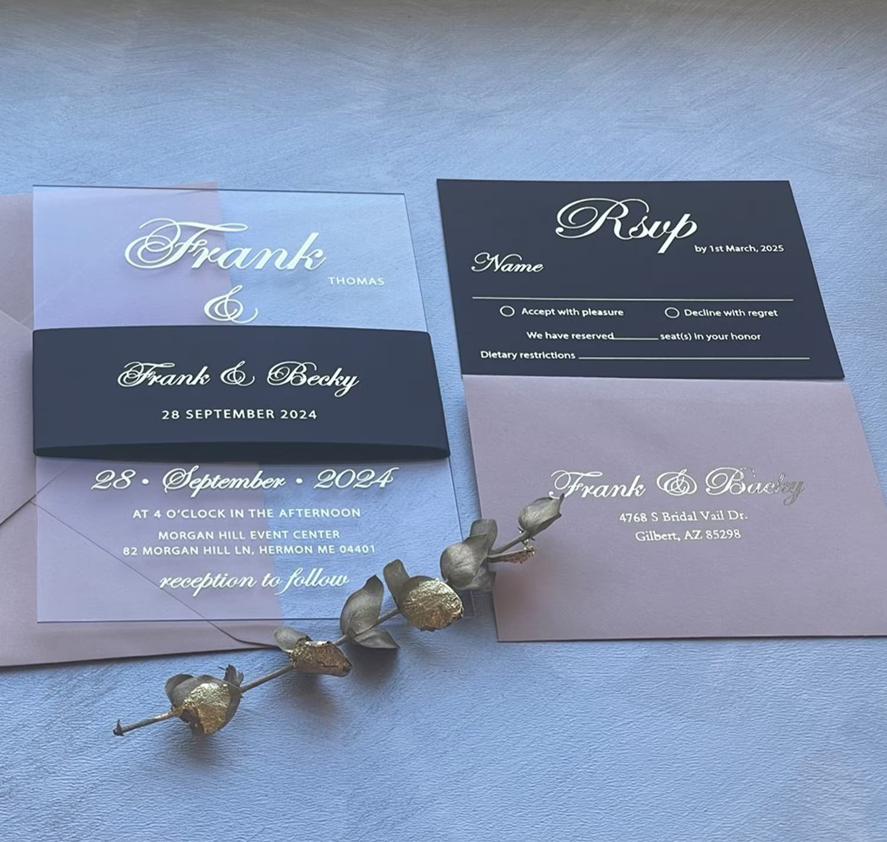 Acrylic wedding invitation suite with a foiled belly band, QR code RSVP card and blush envelope printed with the couple's names and address