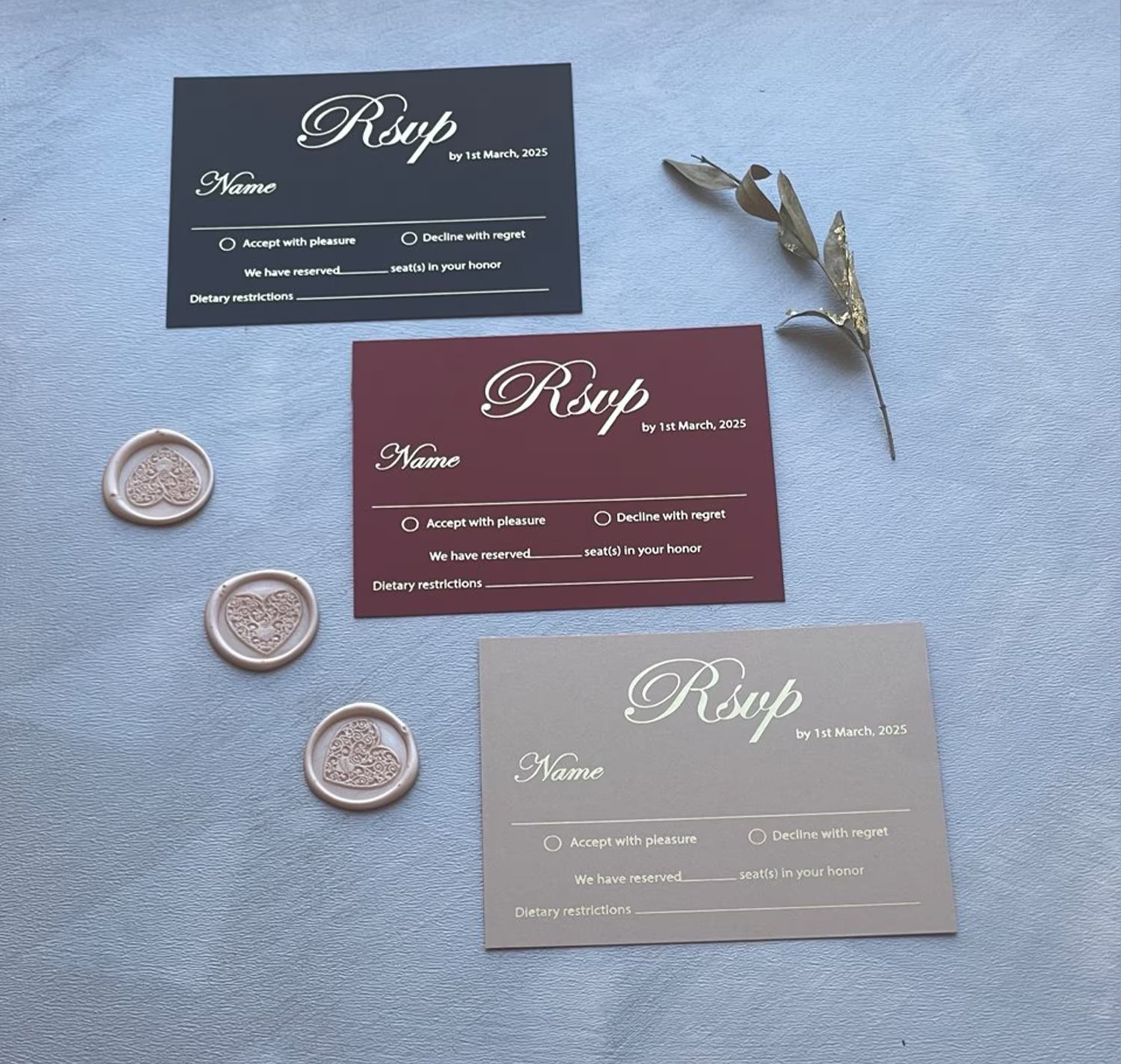 Three wedding RSVP cards in navy, burgundy and taupe with foil calligraphy and accept or decline options