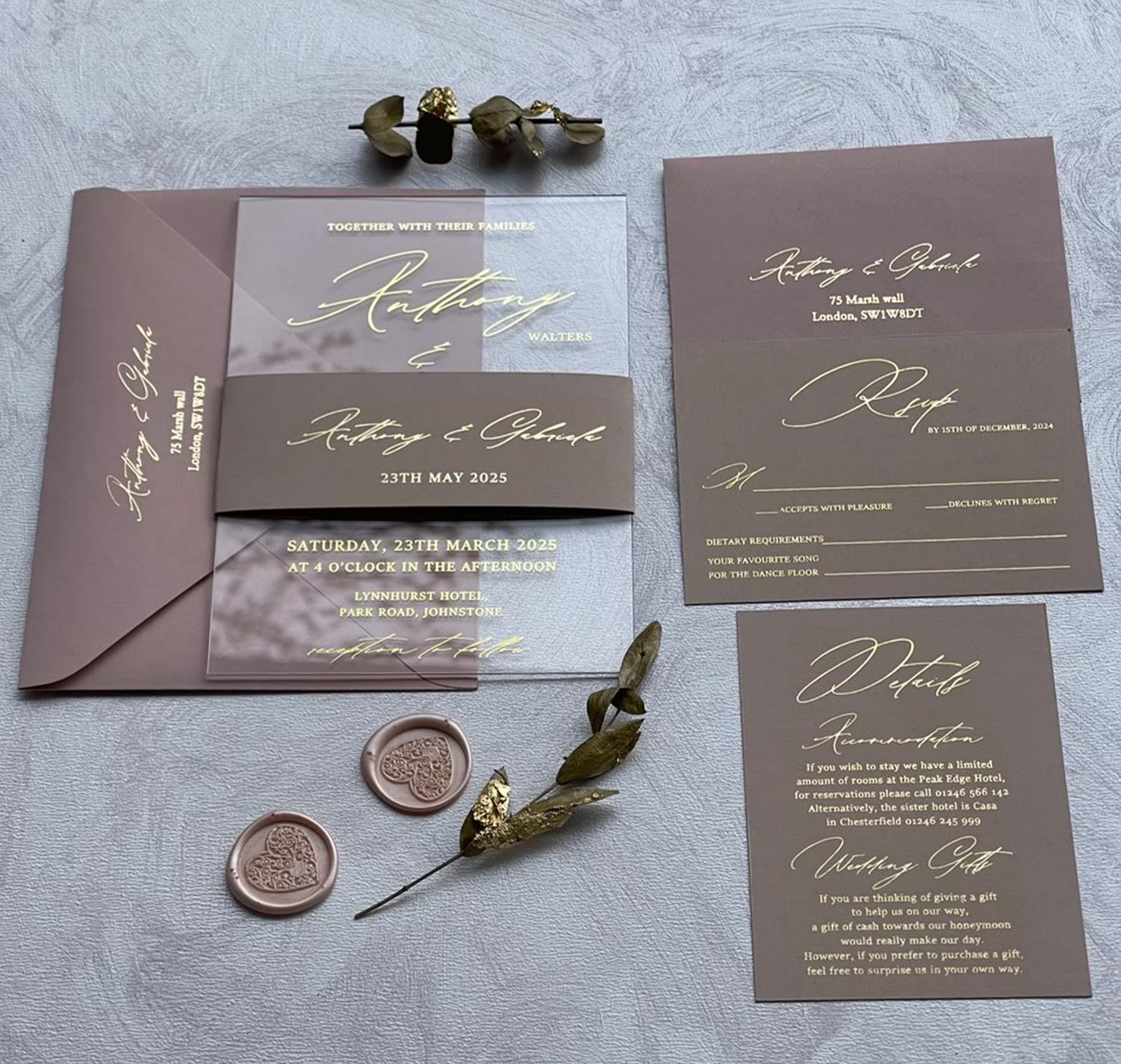 Clear acrylic wedding invitation with gold foil names in bold modern calligraphy, shown with a blush envelope, RSVP and details card as a full personalized suite