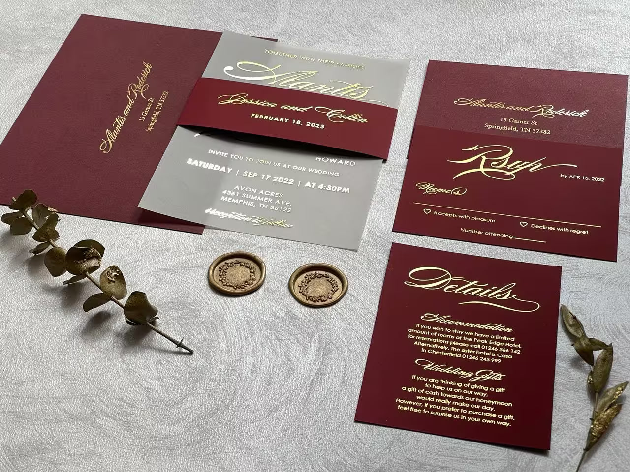Burgundy vellum wedding invitation with gold foil calligraphy and a matching belly band