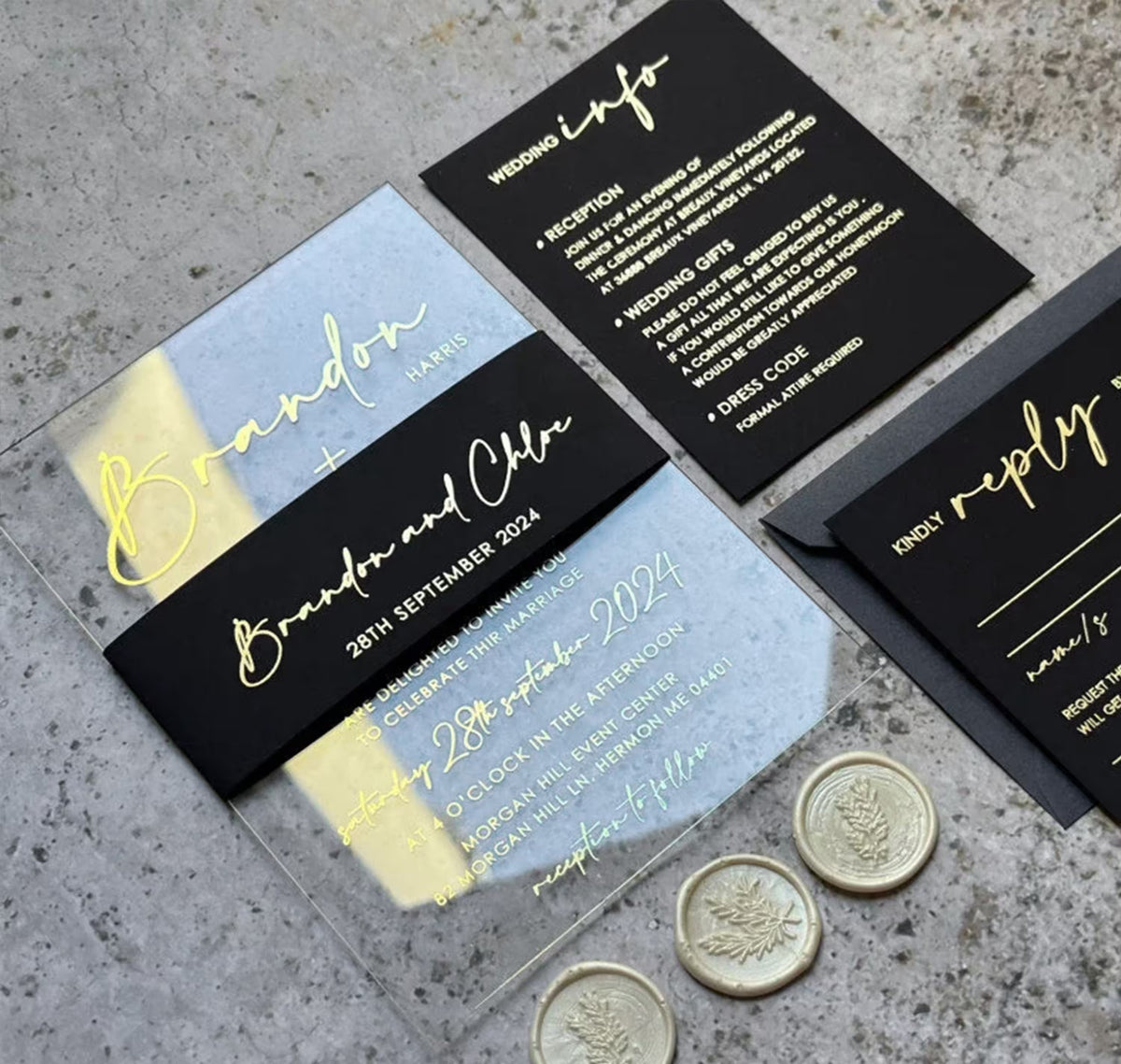 Close up of clear acrylic wedding invitation with personalized foil names, wedding date and modern belly band