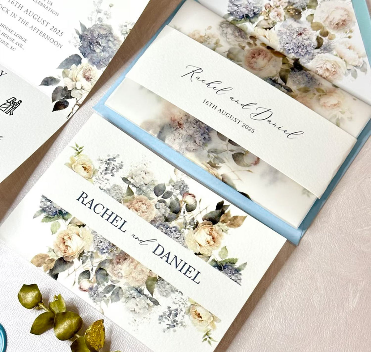 Concertina wedding invitations in dusty blue palette with vellum jacket and wax seal detail