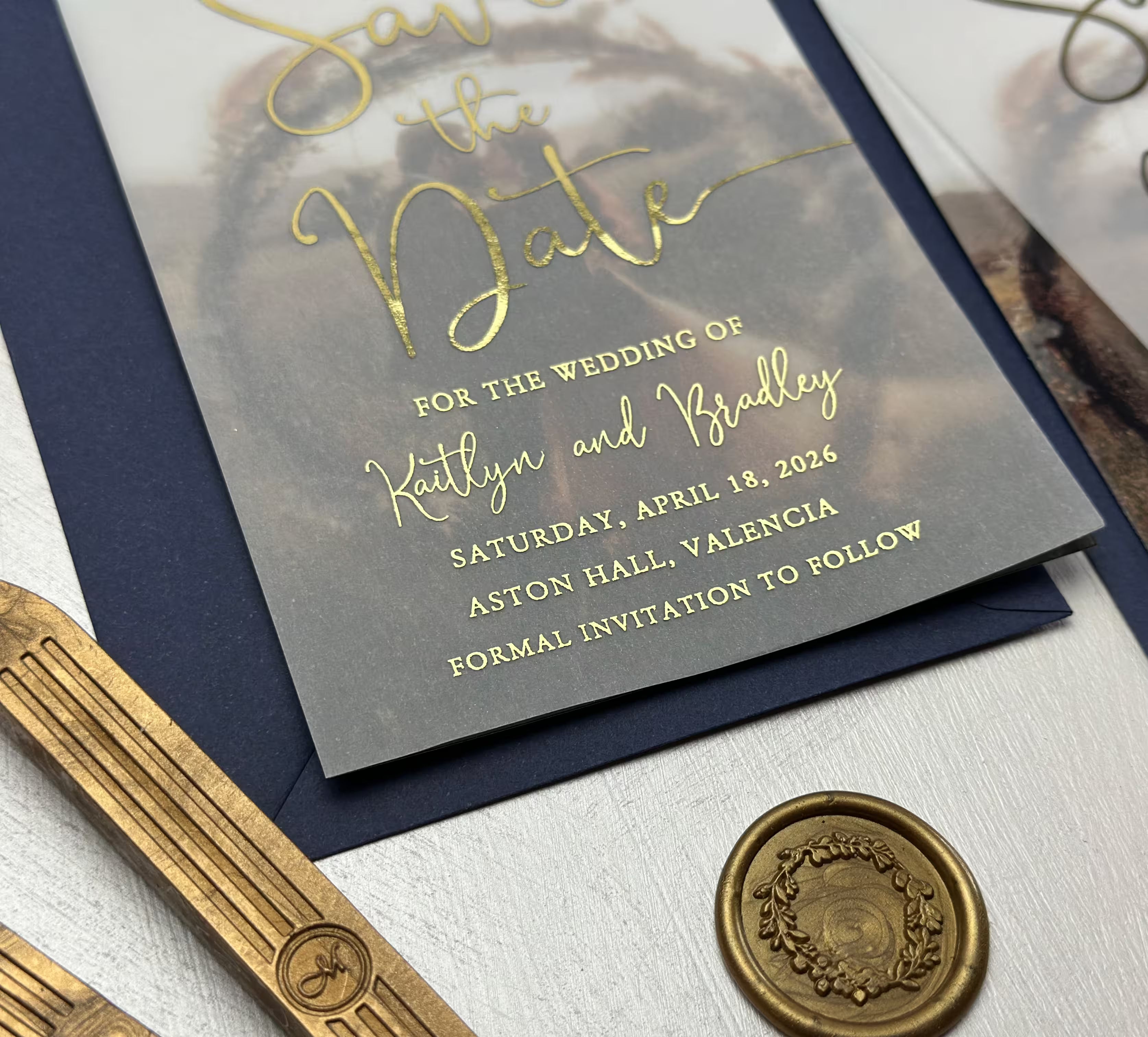 Elegant vellum photo wedding Save the Date with a softly visible photograph and foil calligraphy