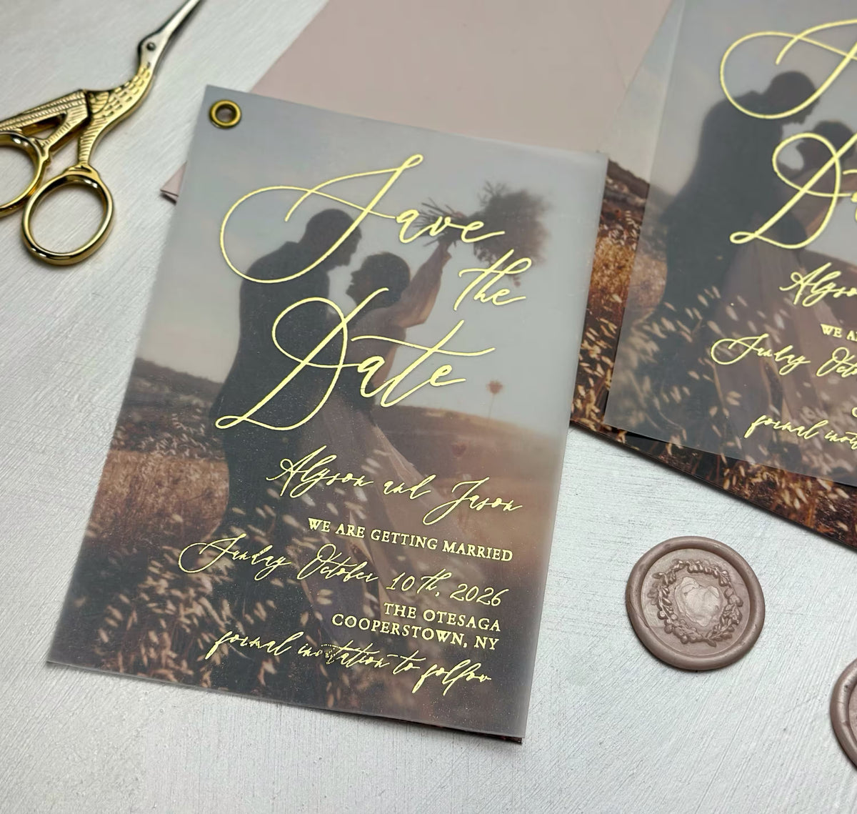 Save the date card with couple photo and vellum overlay shown with wax seal and envelope