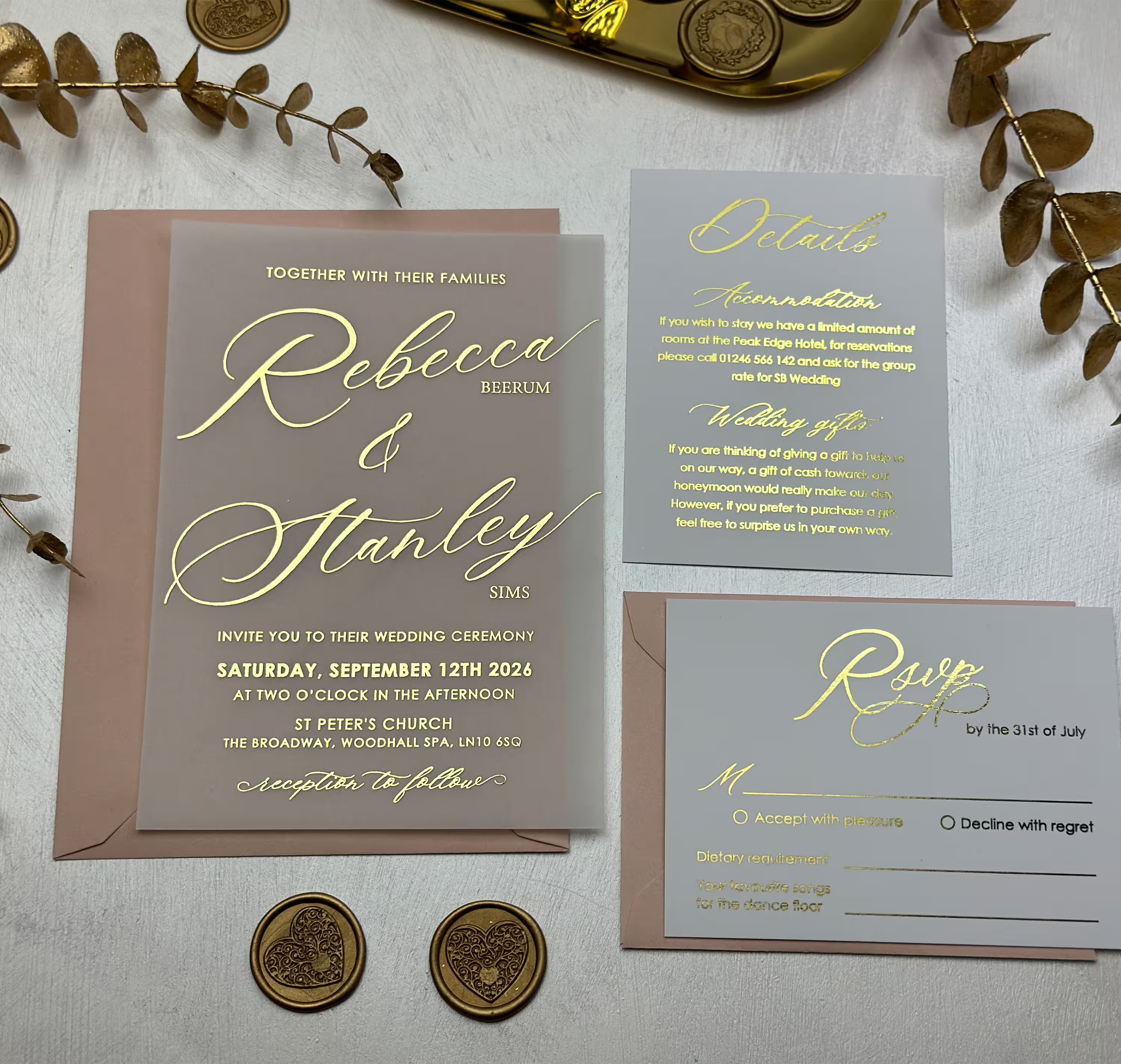 Vellum paper wedding invitation with gold foil calligraphy names layered over a blush envelope, shown with grey RSVP and details cards