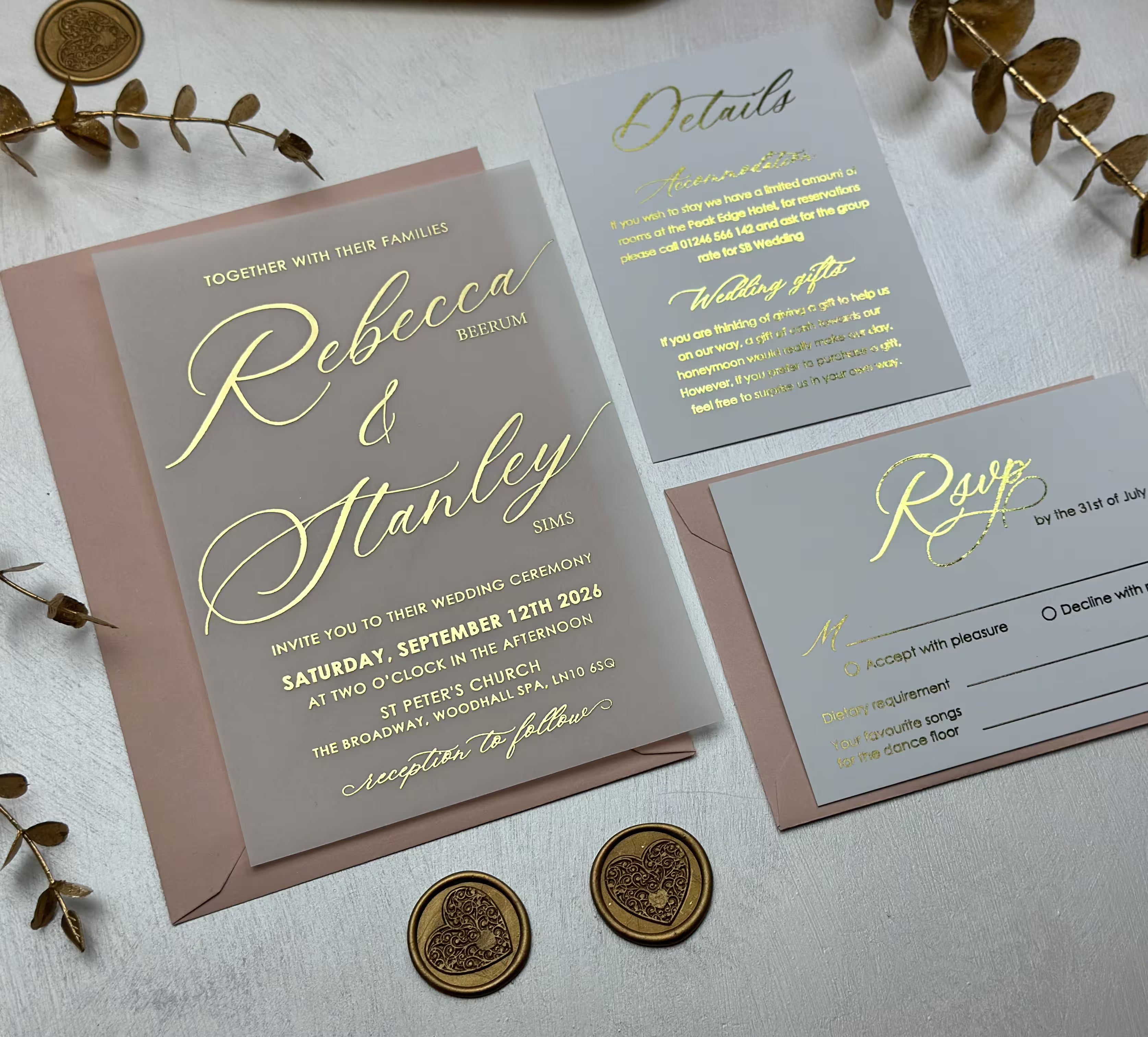 Vellum jacket wedding invitation over a blush envelope, paired with a grey RSVP card and a foiled belly band