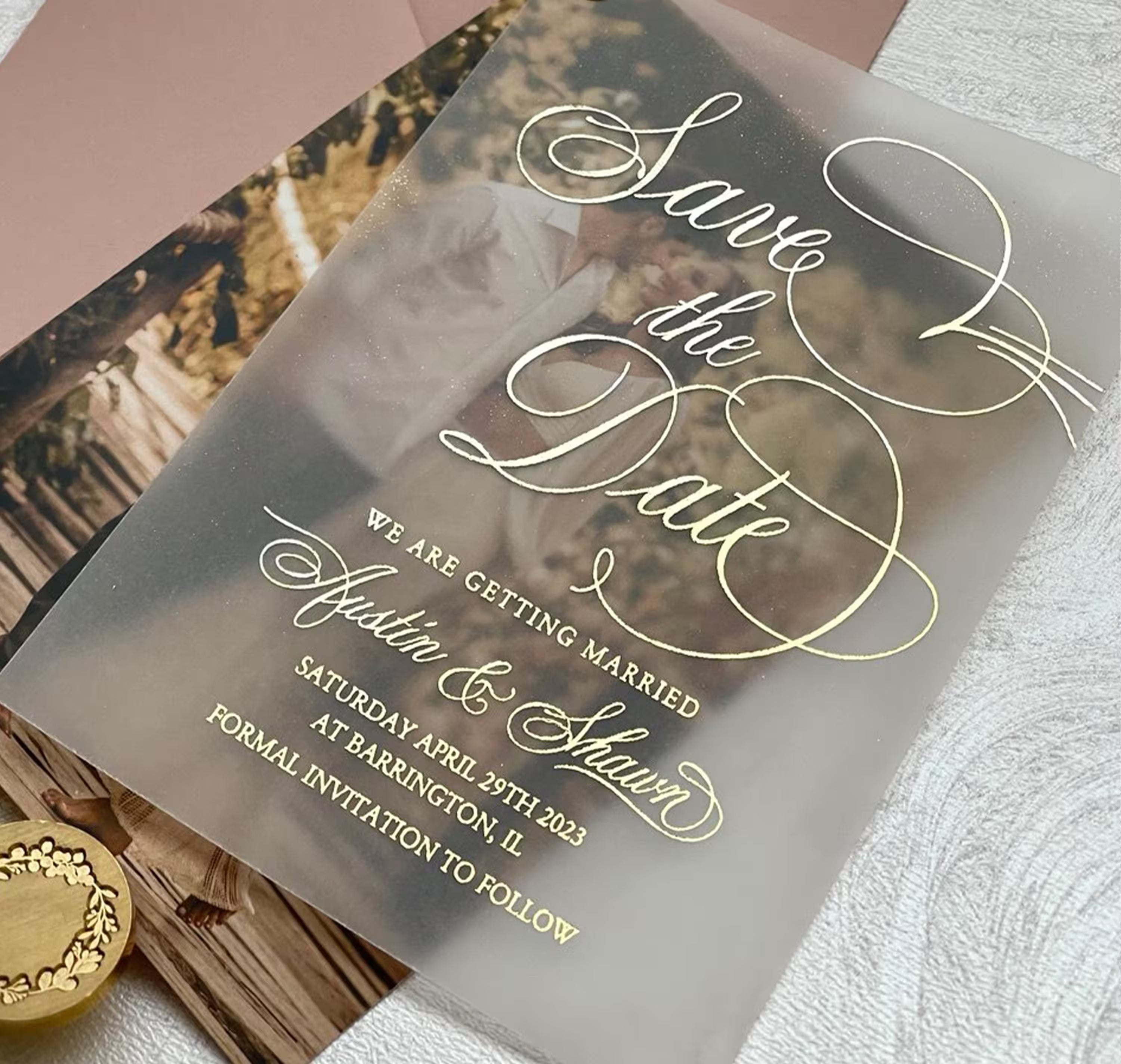 Vellum wedding save the date with a couple photo beneath translucent vellum and elegant foil typography