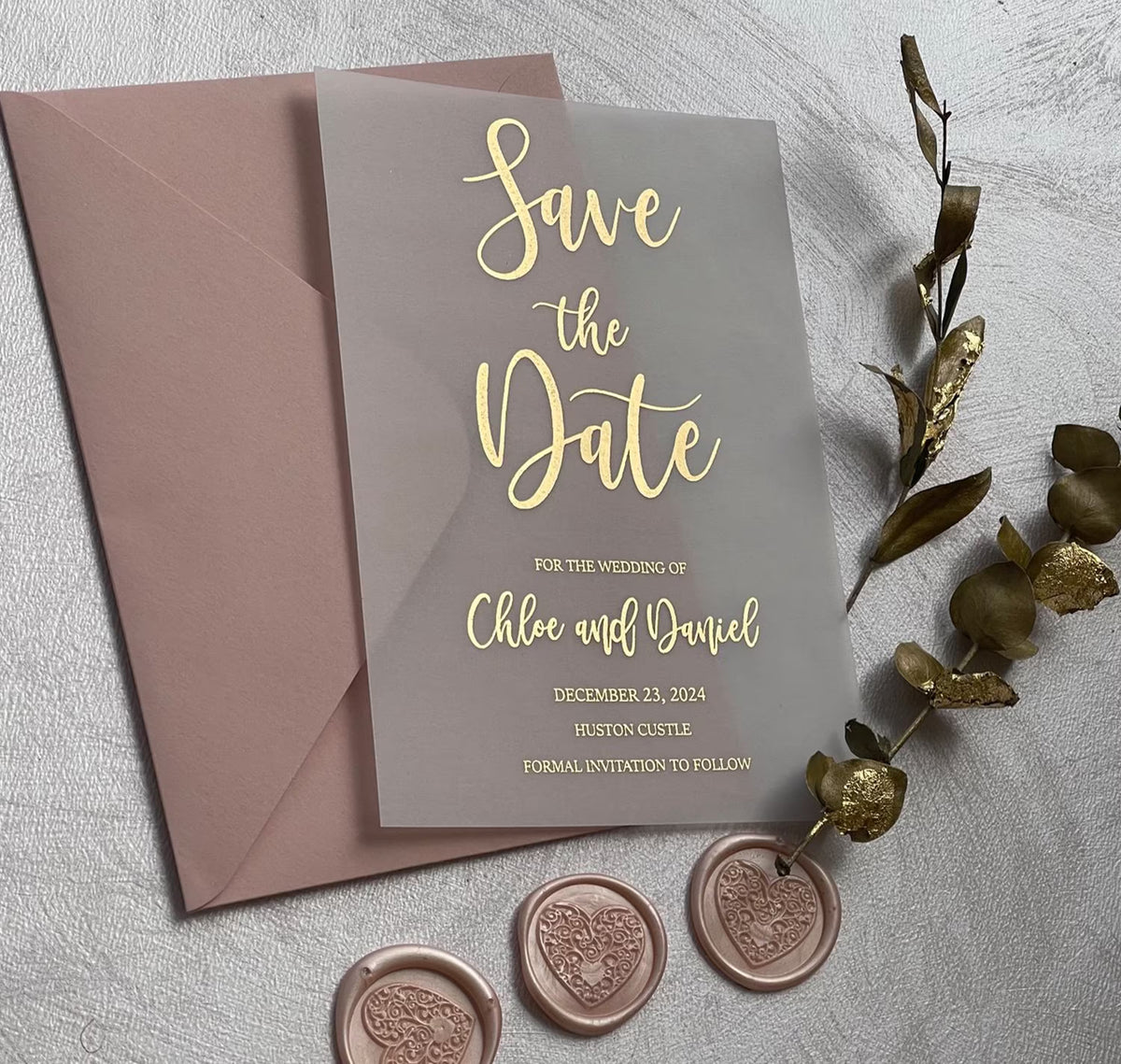 Wedding save the dates on translucent vellum with foil script lettering, personalized with the names, date and venue.