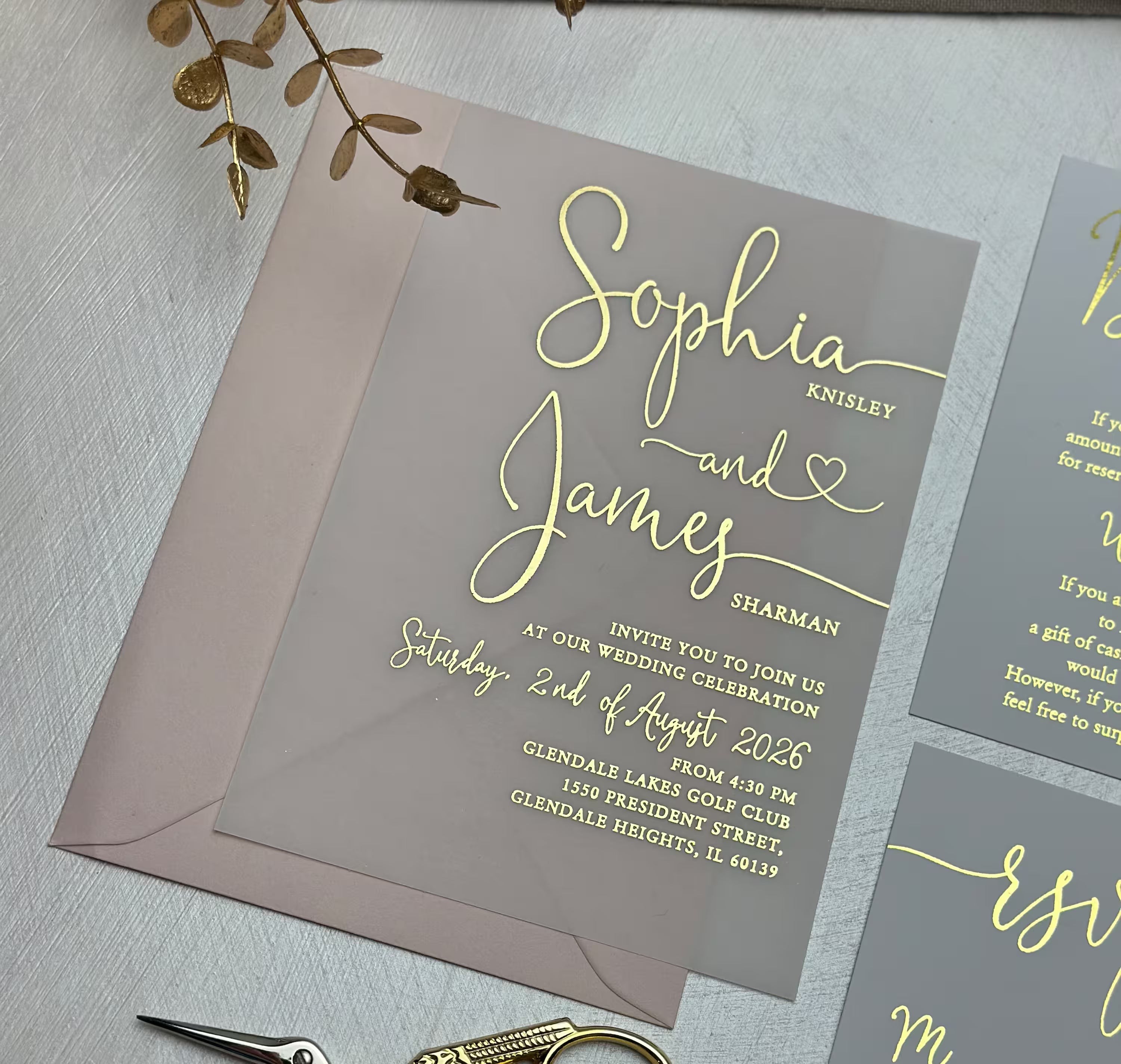 Vellum invitation paper with elegant wedding lettering, delicate foil details and romantic heart accent
