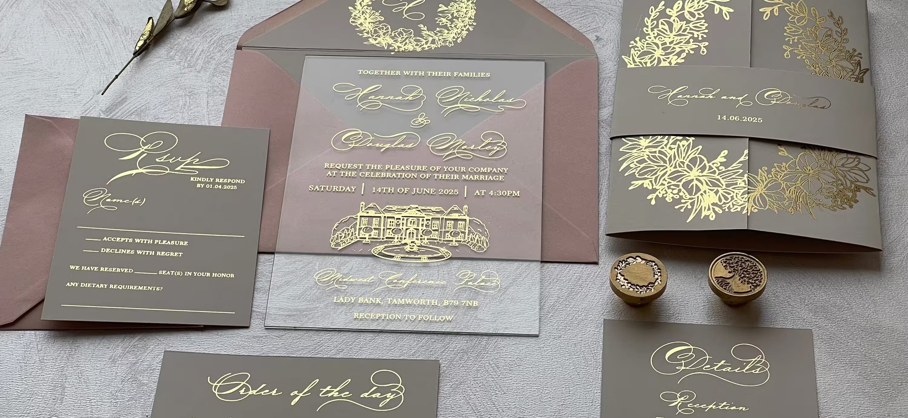 Clear acrylic wedding invitation with gold foil monogram and calligraphy, wrapped in a taupe belly band, with matching details and RSVP cards, envelope, and wax seal