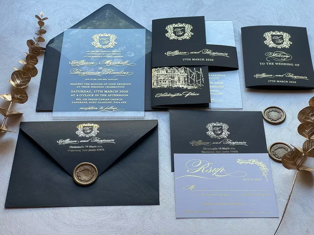 Belly band with a gold foil monogram crest wrapping the acrylic invitation suite