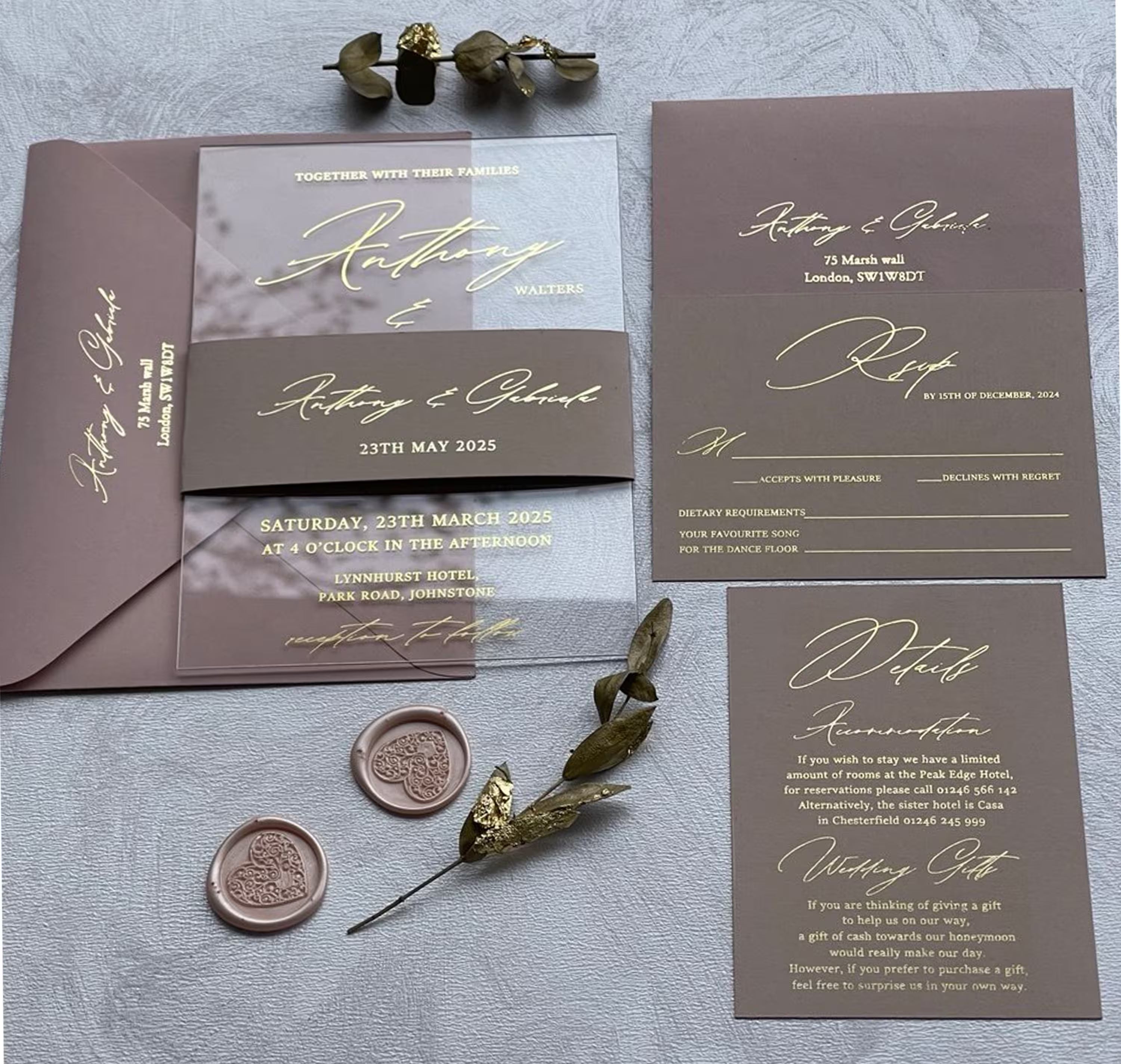 Gold foil RSVP and details cards in flowing calligraphy, with the order of the day, accommodation and gift notes beside the clear acrylic invitation