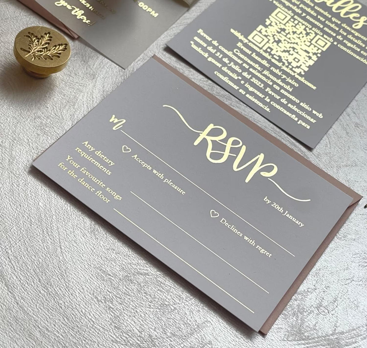 Birthday party invitations on vellum beside an envelope, a personalized invitation with foil lettering for a milestone birthday.