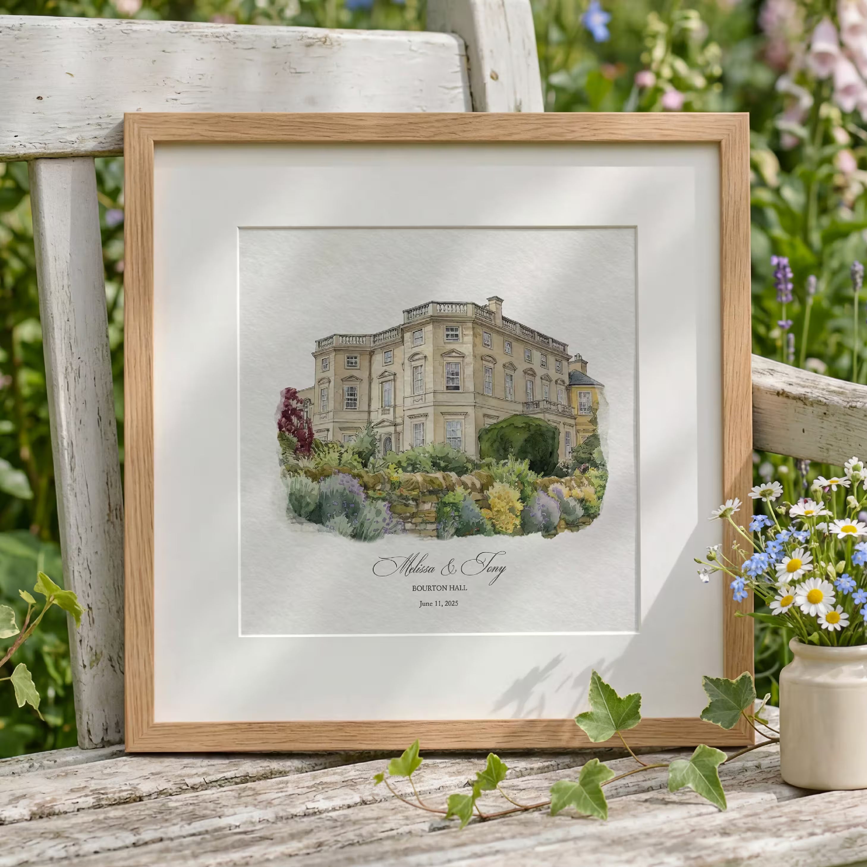 Minimalist watercolor portrait of Bourton Hall, a honey stone country house above a lavender garden wall, in an oak frame with a white mat. Created from your photo and personalized with the couple names and wedding date, a paper first anniversary gift.