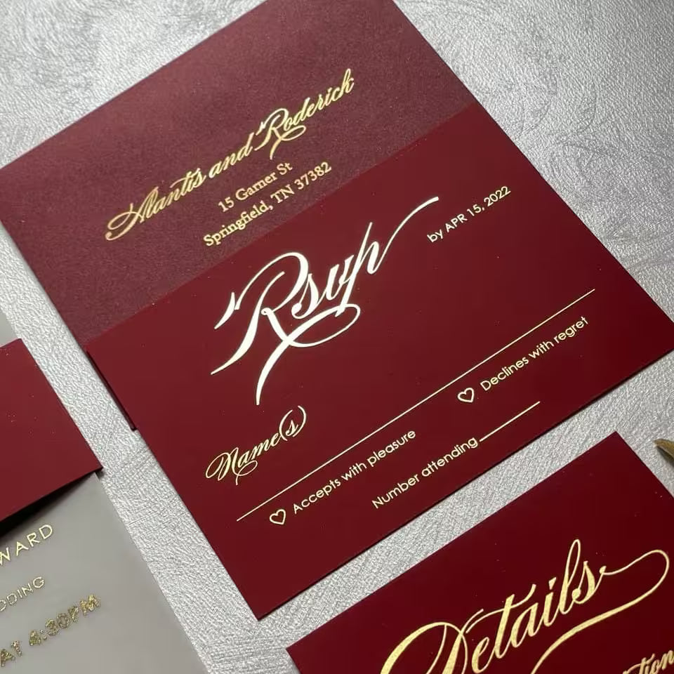 Burgundy RSVP and details cards with gold foil calligraphy from a vellum wedding invitation suite