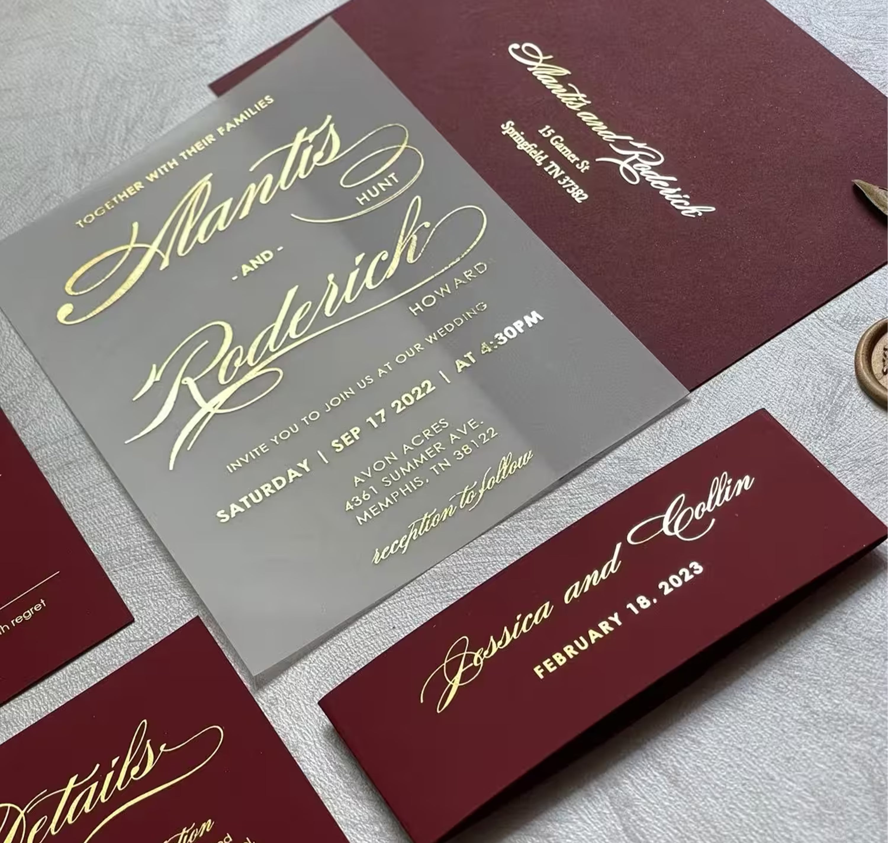 Burgundy vellum wedding invitation with gold foil calligraphy, burgundy envelope, belly band, and matching RSVP and details cards