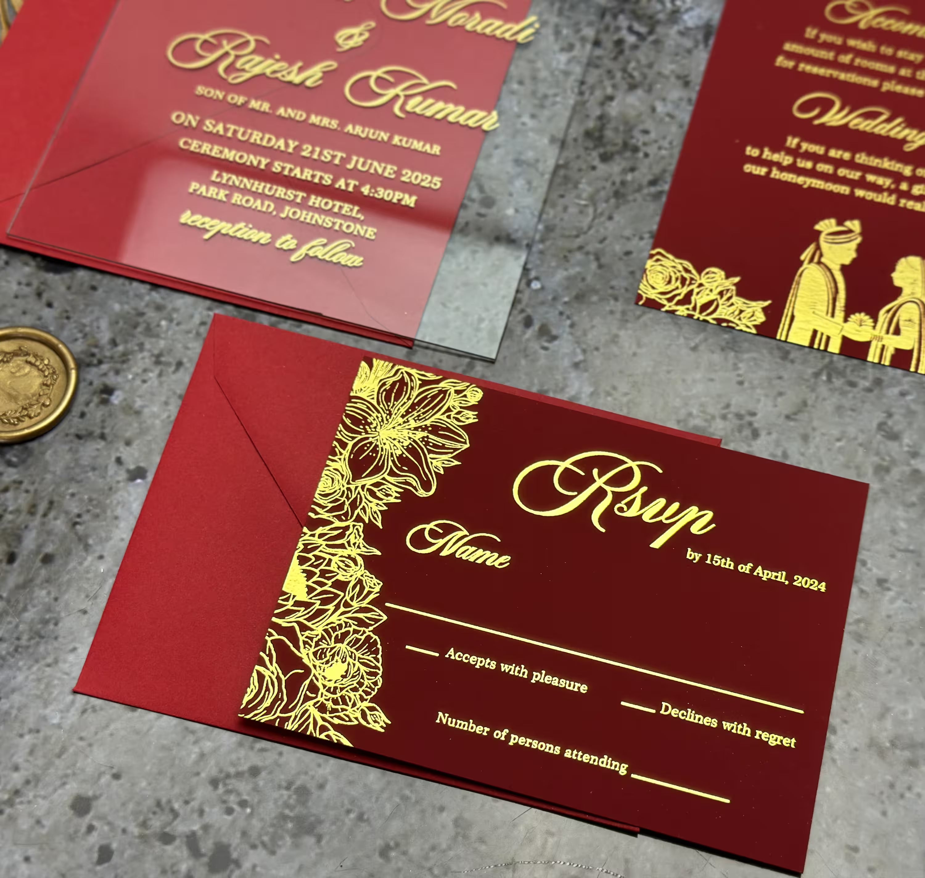 Deep burgundy envelope sealed with a custom gold wax seal monogram for an elegant South Asian wedding invitation