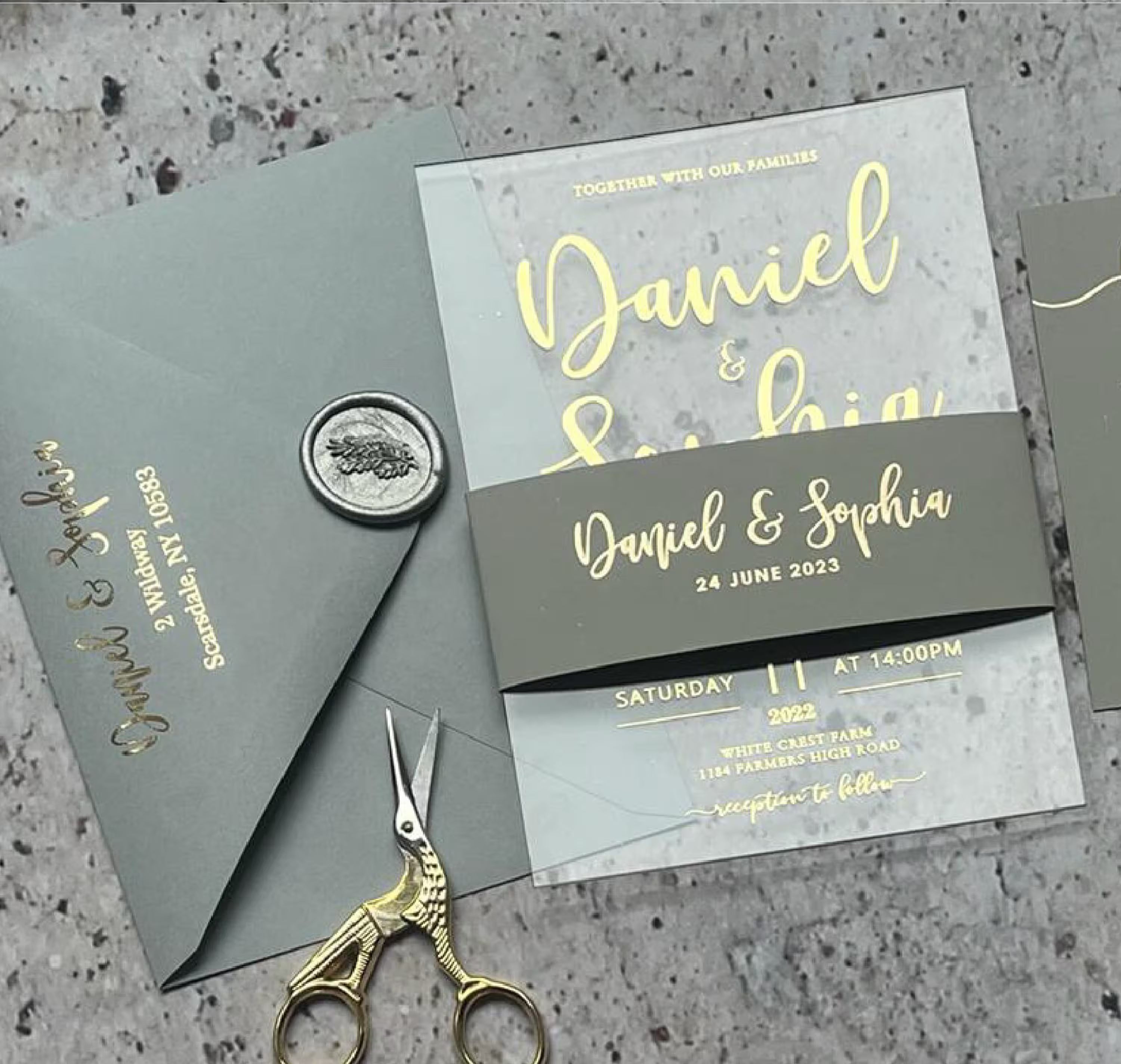 Clear acrylic wedding invitation with personalized names and foil details