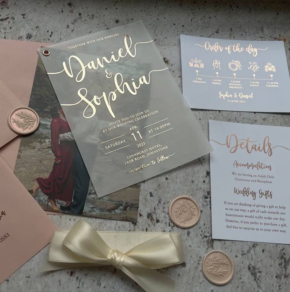 Custom photo wedding invitation card with foil calligraphy, shown with burgundy envelope and ribbon