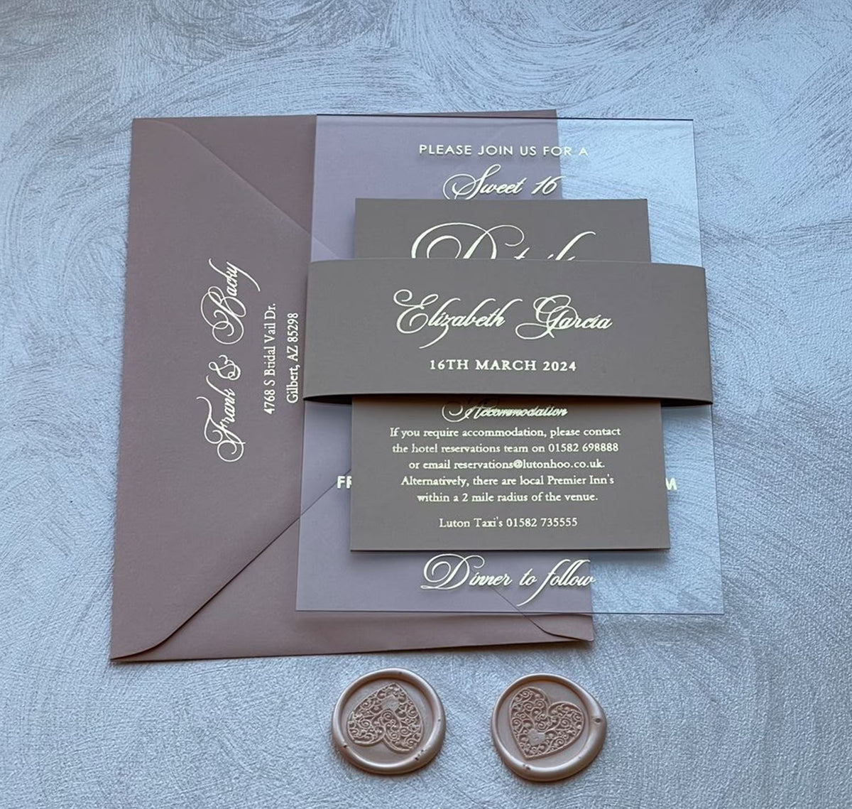 Elegant sweet 16 invitations on clear acrylic with foil lettering, a personalized 16th birthday invitation with a belly band for an unforgettable night.