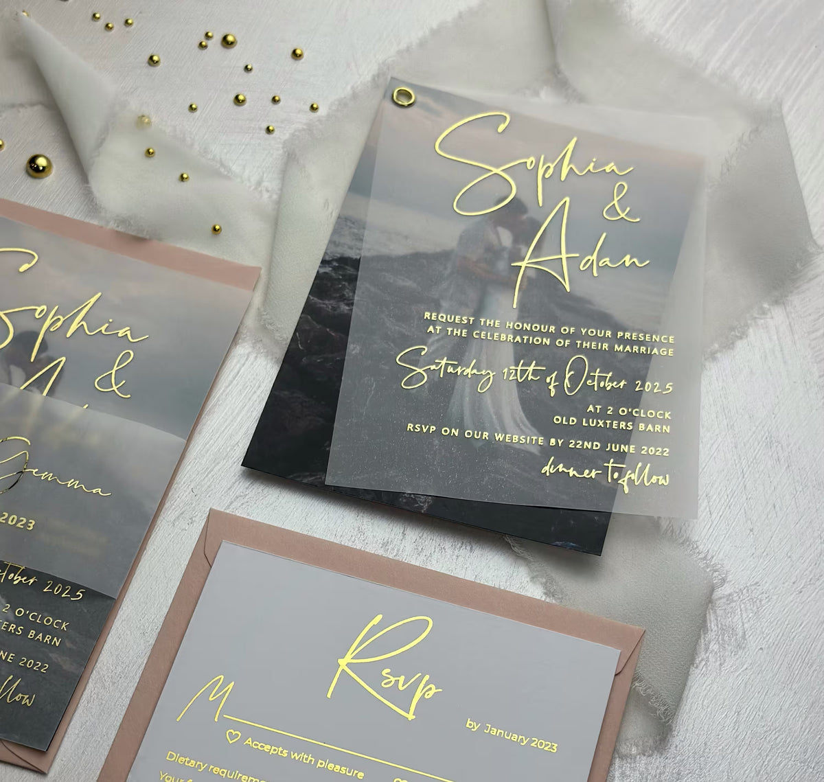 Foil vellum wedding invitation suite with names over a couple photo and gold grommet