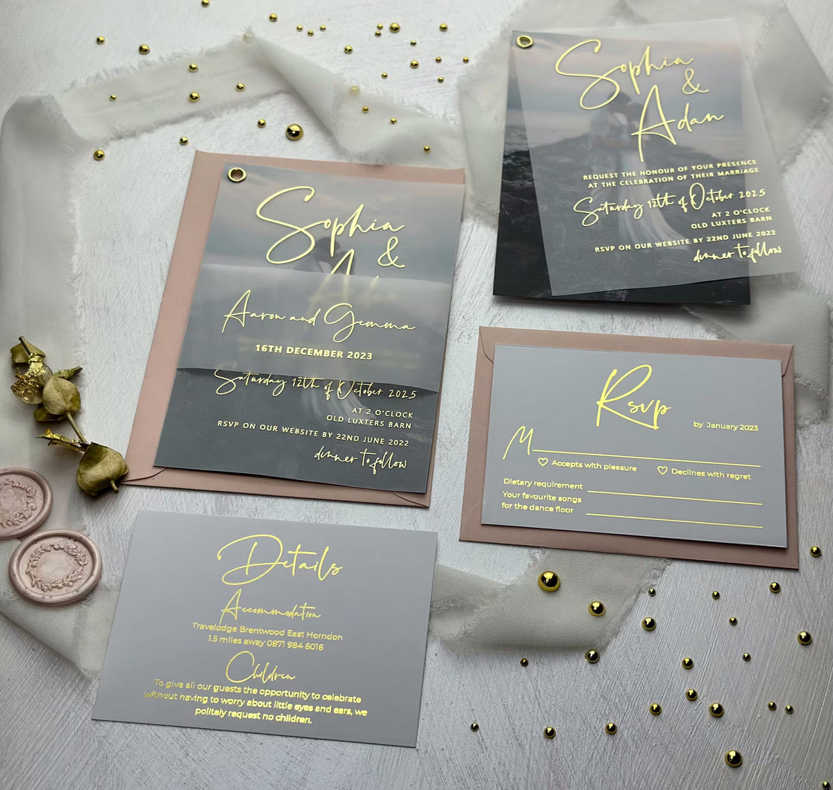 Foil vellum wedding invitation suite flat lay with envelope, RSVP card, and wax seals