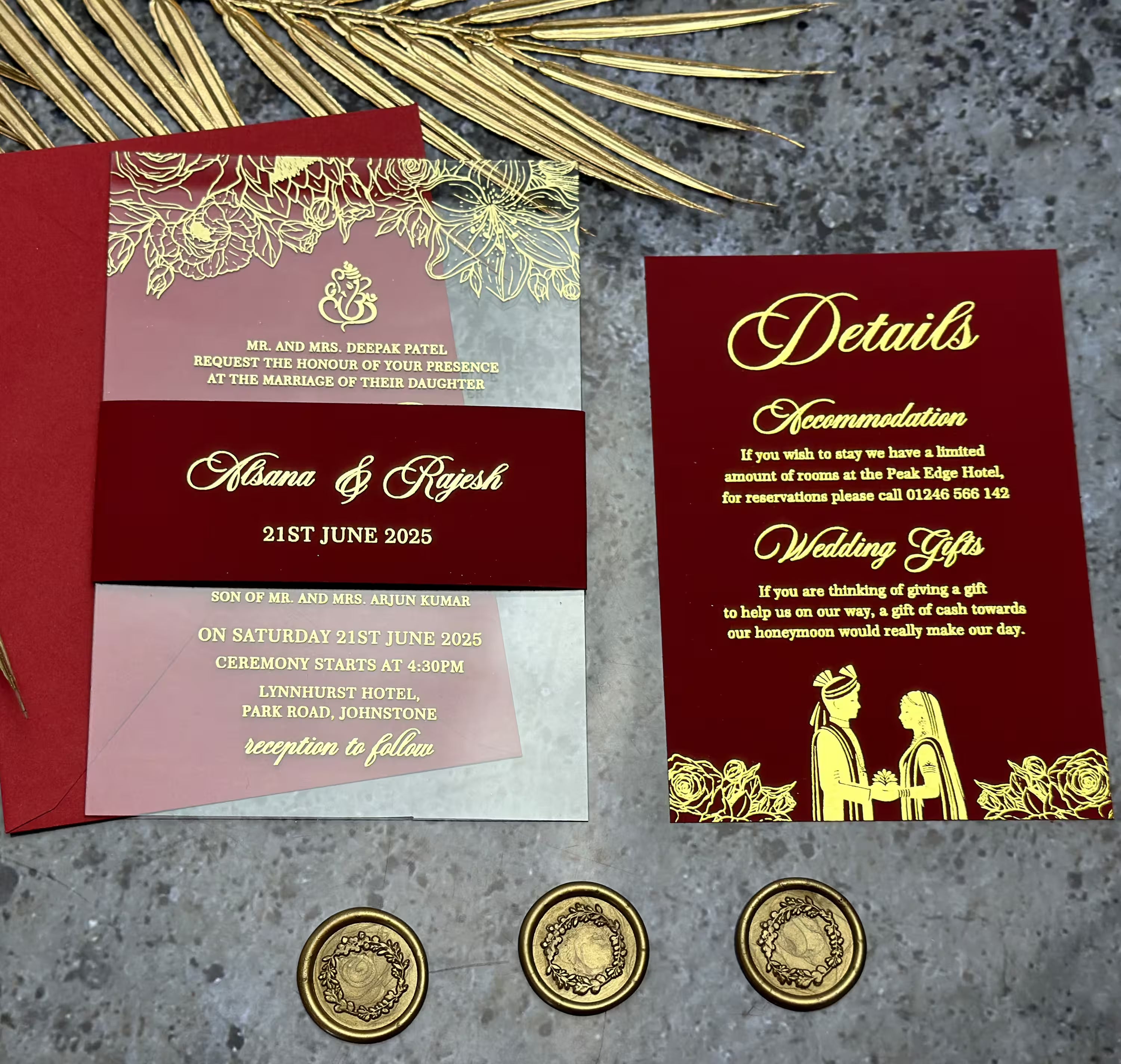 Close-up of a premium frosted acrylic Desi wedding invitation featuring intricate gold foil typography and traditional motifs