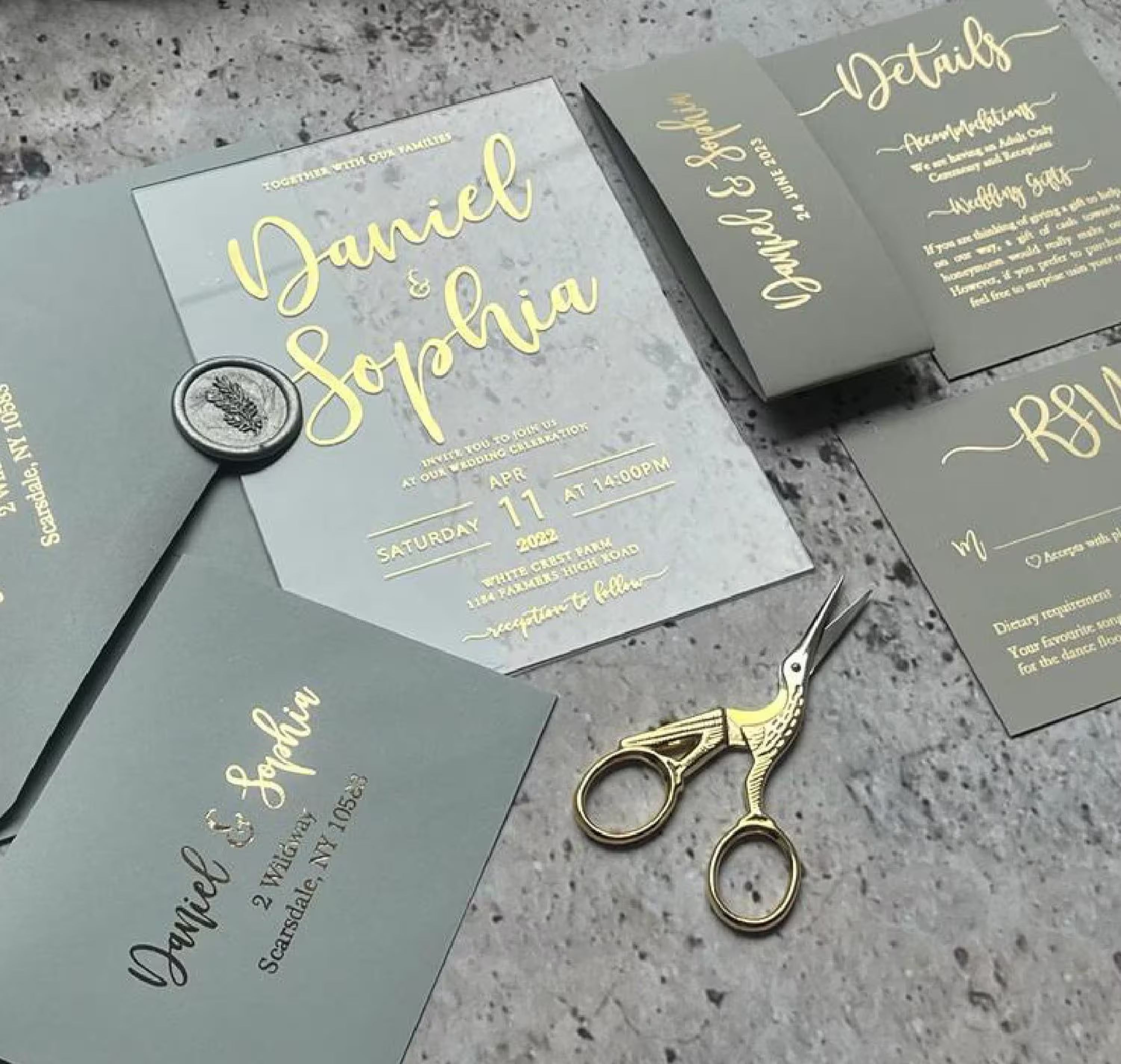 Modern acrylic wedding invitation with elegant foil lettering and envelope