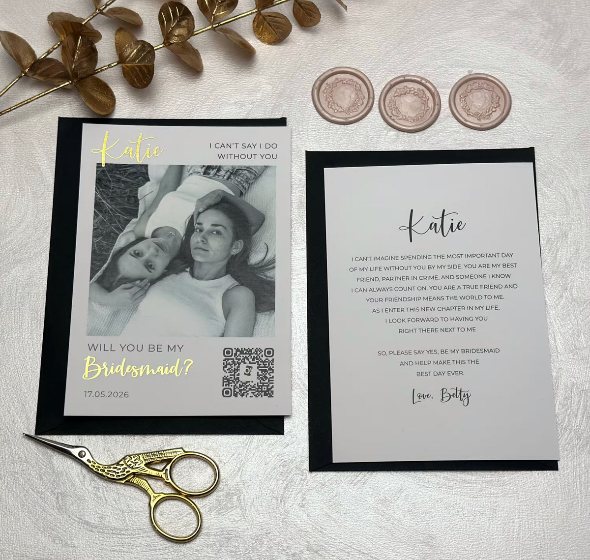 Close-up of a personalized proposal card set with a photo, elegant foil lettering, and a matching message card.
