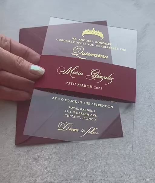 Video of acrylic quinceañera invitations with a foil tiara and script lettering on clear acrylic, personalized quince invitation with a belly band.