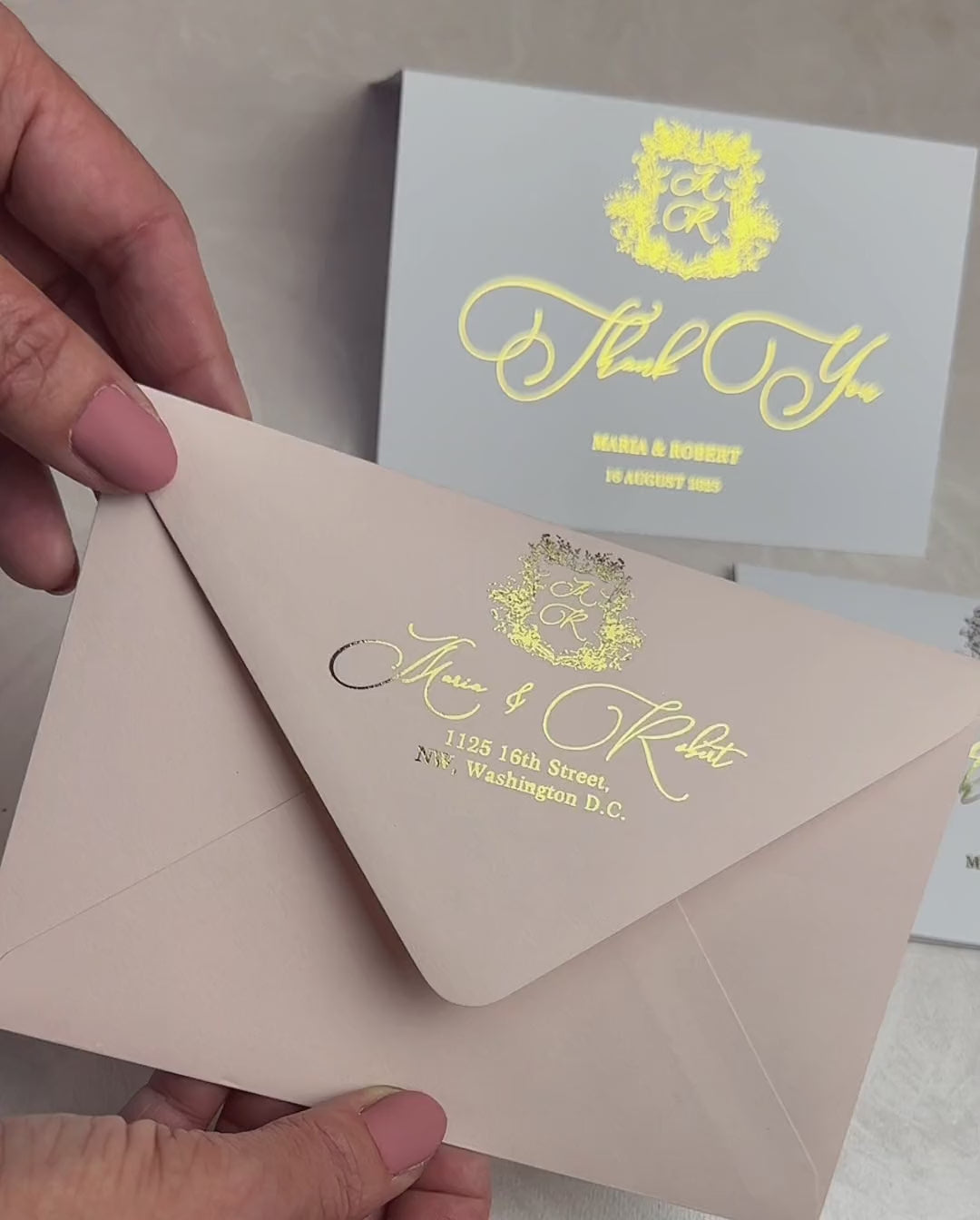 Video of wedding thank you notes with floral crest monogram and foil script, taken out of an optional envelope
