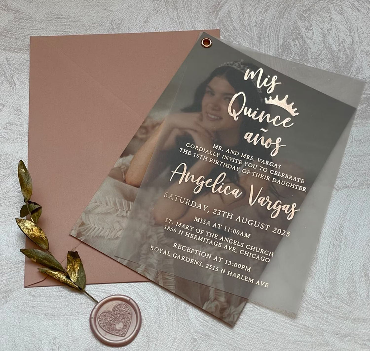 Close-up of foil lettering on a quinceañera invitation, with the name, date and details shown over a photo on translucent vellum.