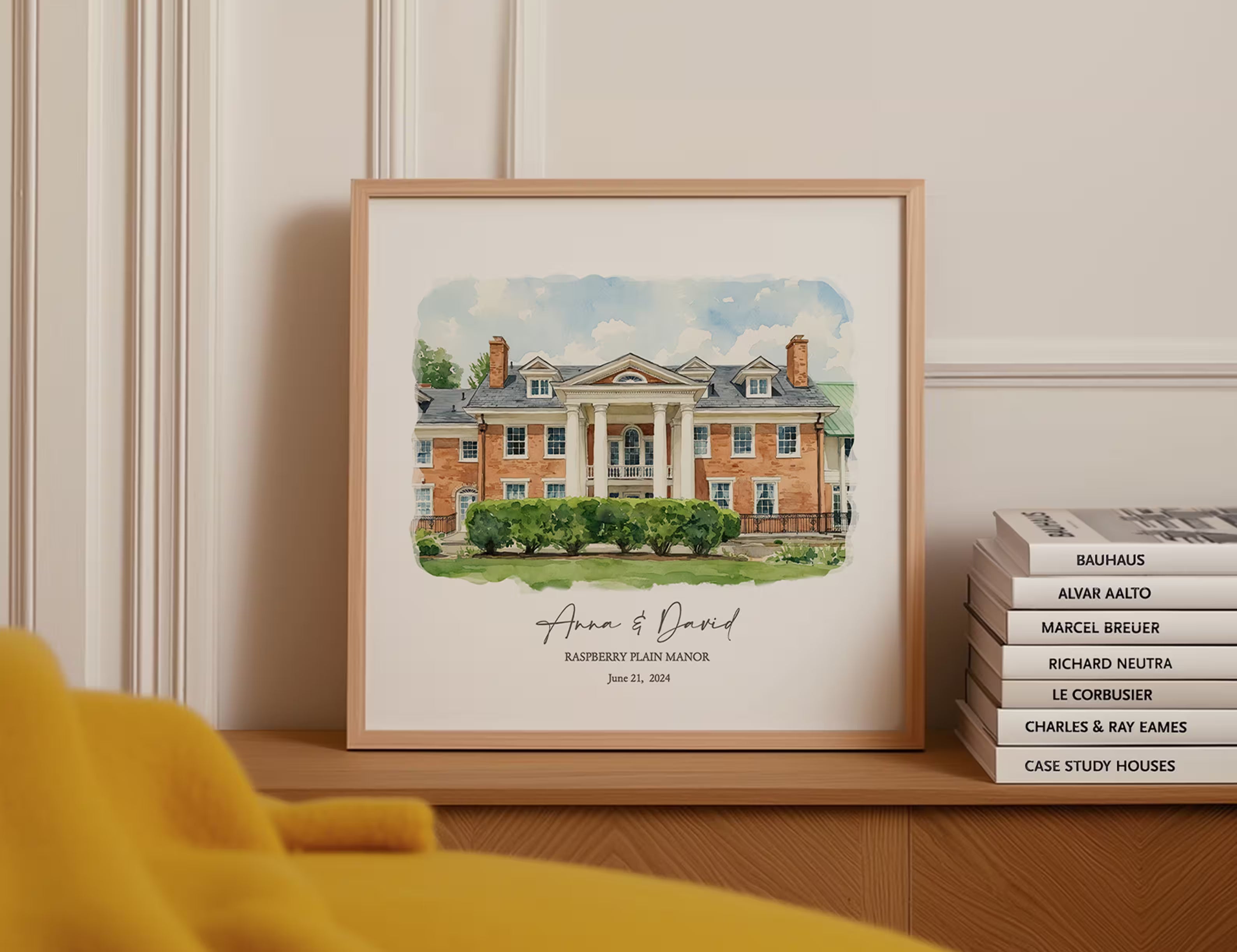 Custom watercolor portrait of Raspberry Plain Manor in a light wood frame, a personalized wedding anniversary gift displayed on a shelf, as the header for the Anniversary Gifts by Year collection