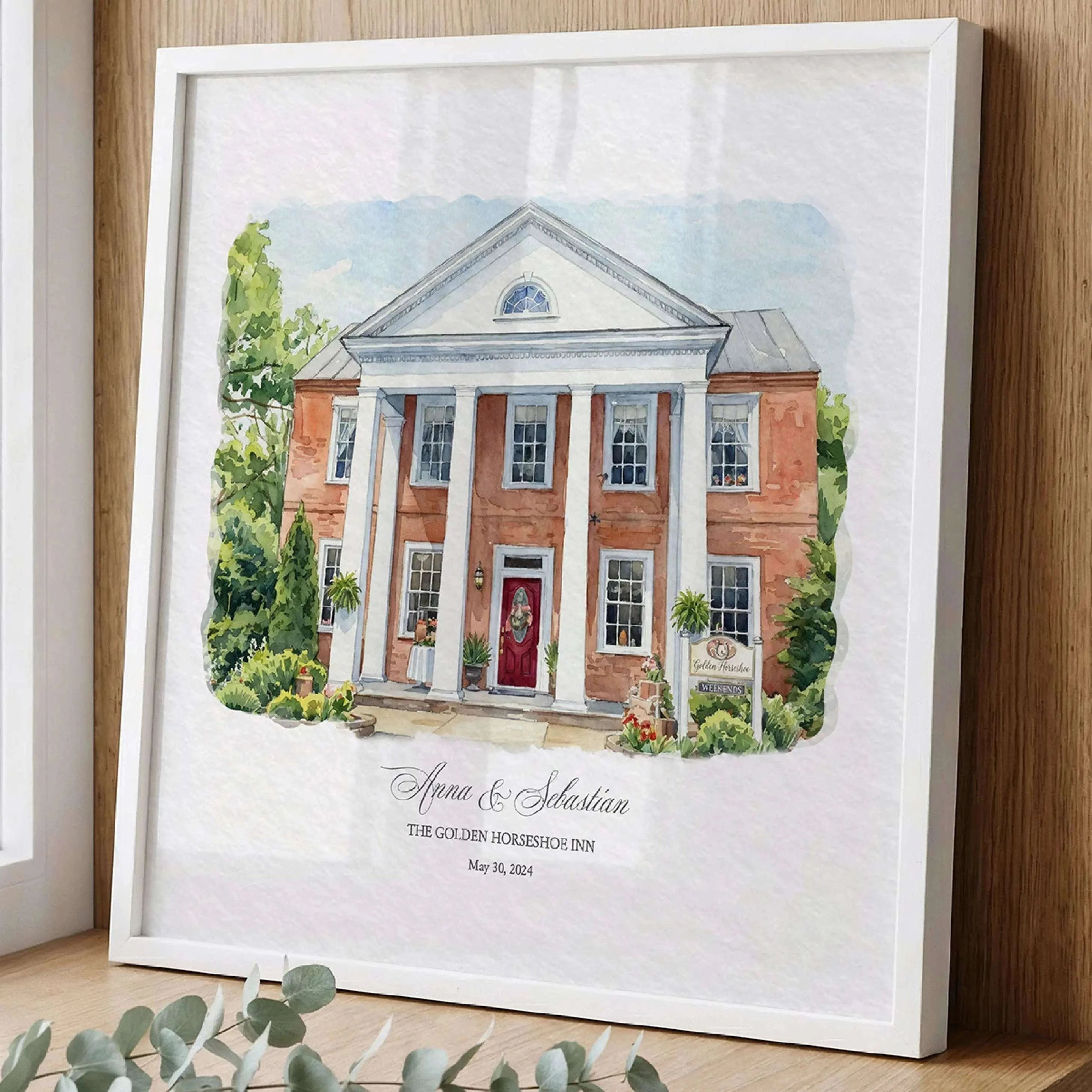 Framed watercolor portrait of The Golden Horseshoe Inn displayed as elegant wedding venue wall art. A custom venue illustration created from a photograph, perfect as a one year anniversary gift, wedding keepsake, or personalized artwork celebrating a special wedding location.