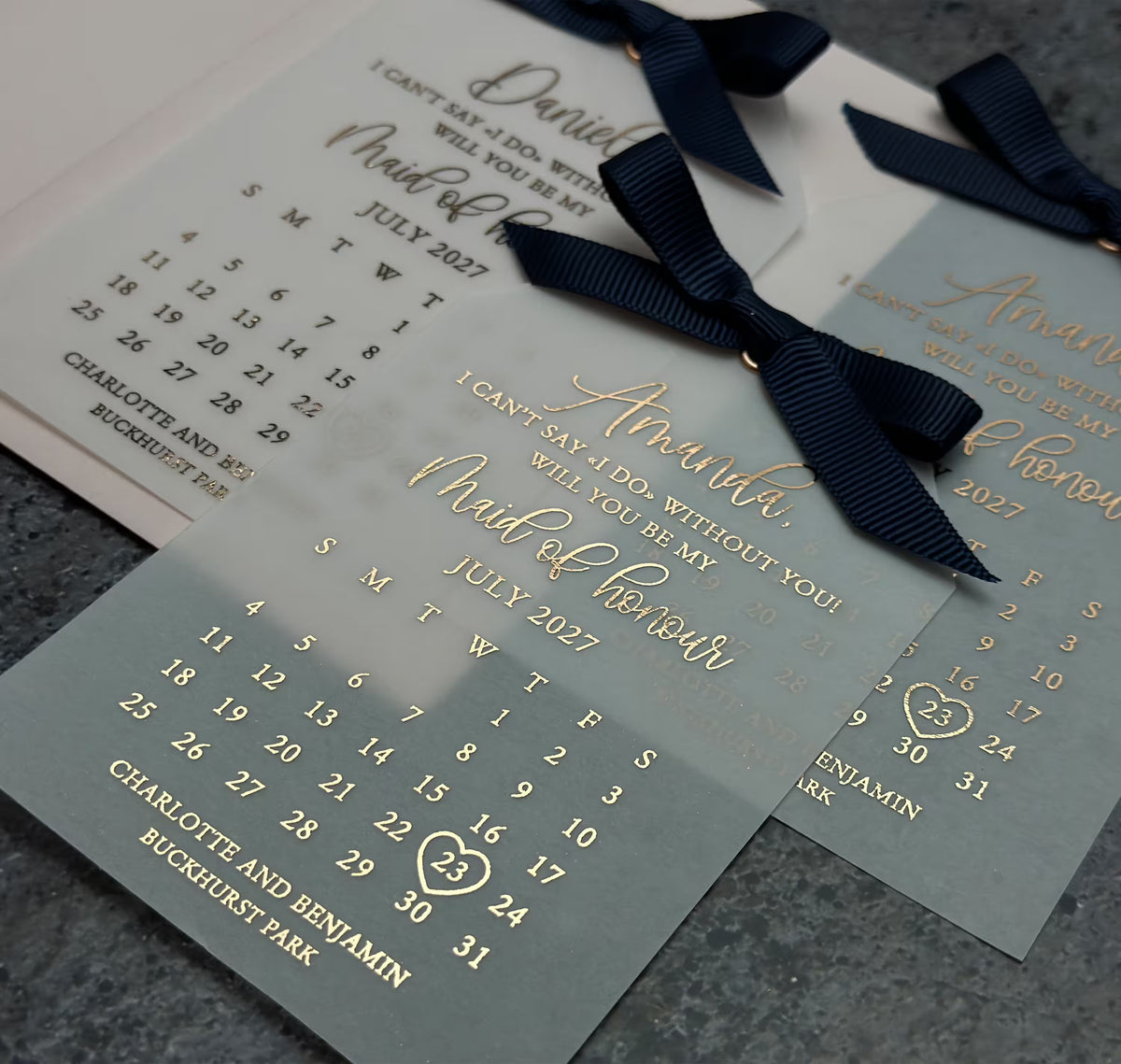 Vellum proposal cards finished with decorative ribbons in different colors to complement a wedding palette.