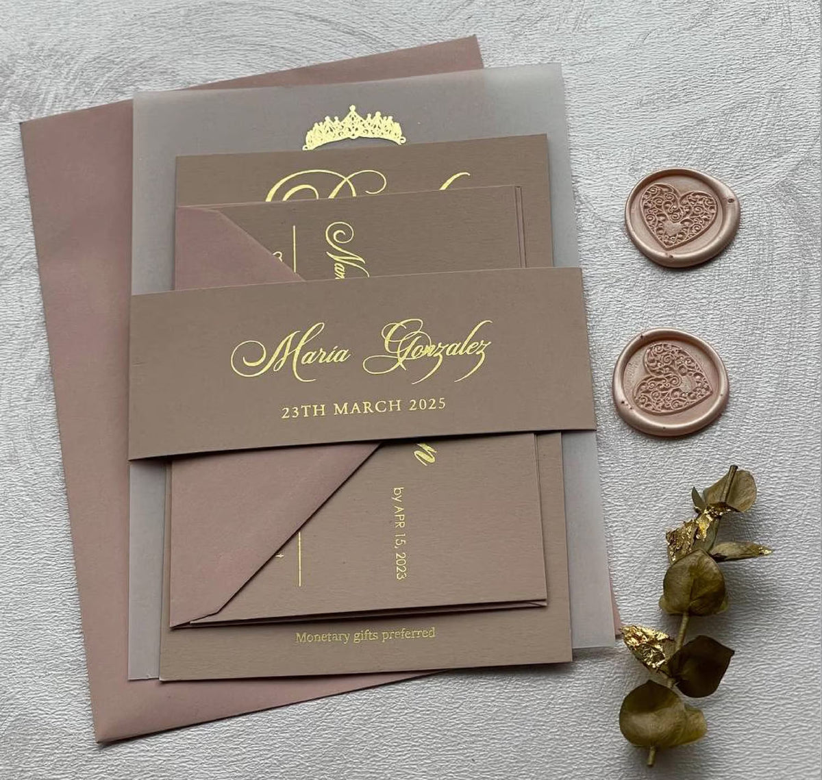 Vellum quinceañera invitations with foil lettering and a tiara, personalized with the name, date and venue.