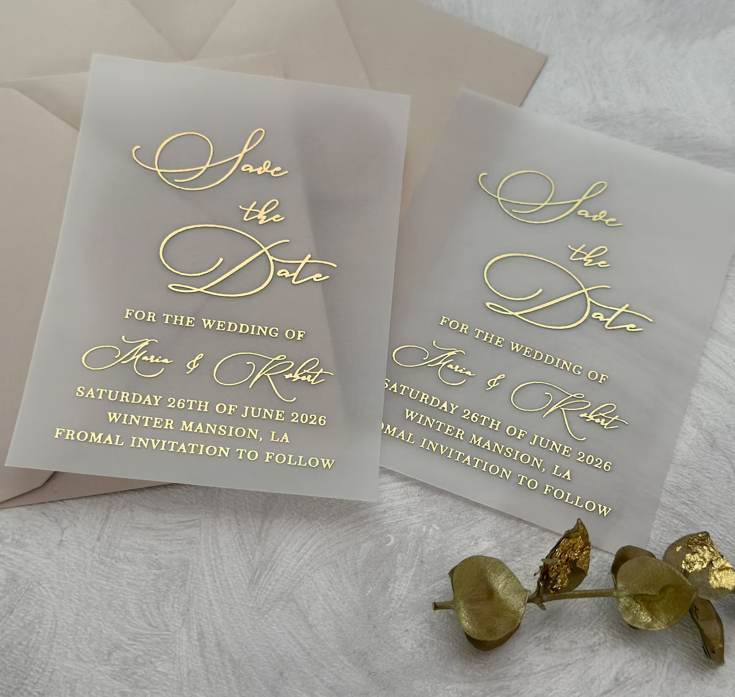 Vellum Save the Date card featuring personalized wedding details and foil